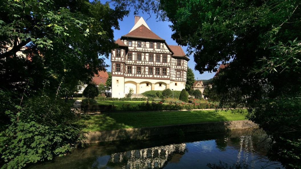 Exterior of Urach Palace with pond in the foreground